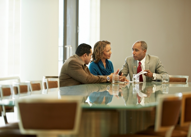 3 people at conference table